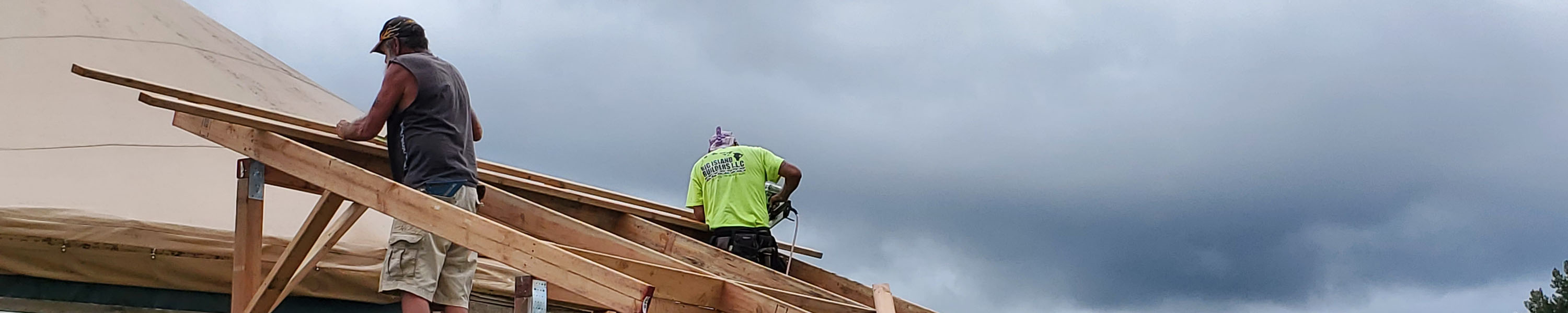 Constructing an overhang over the entrance to one of the yurts