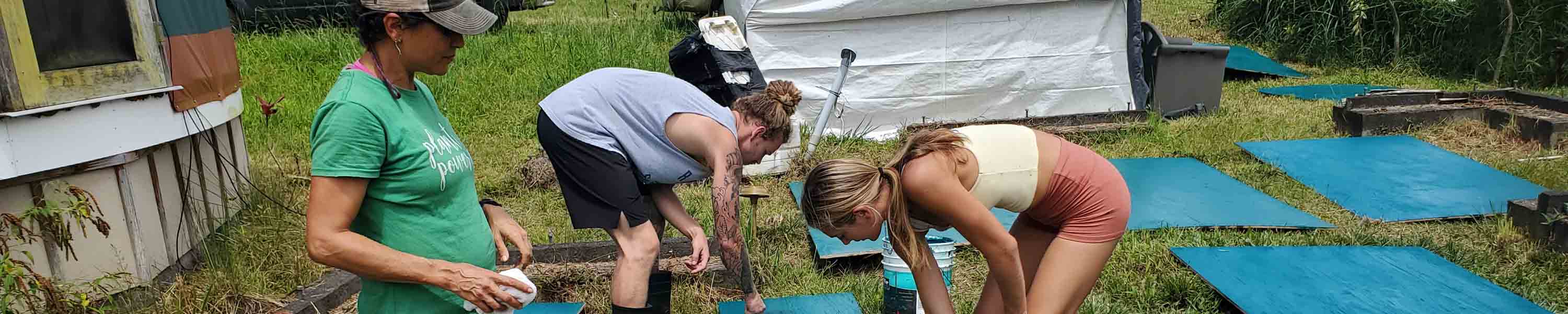 Team members painting wood